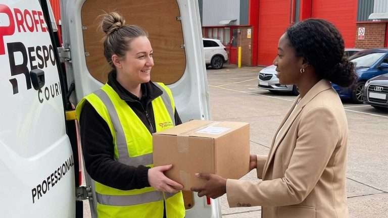 Female delivery driver from Professional Response Couriers handing over a parcel in Leeds